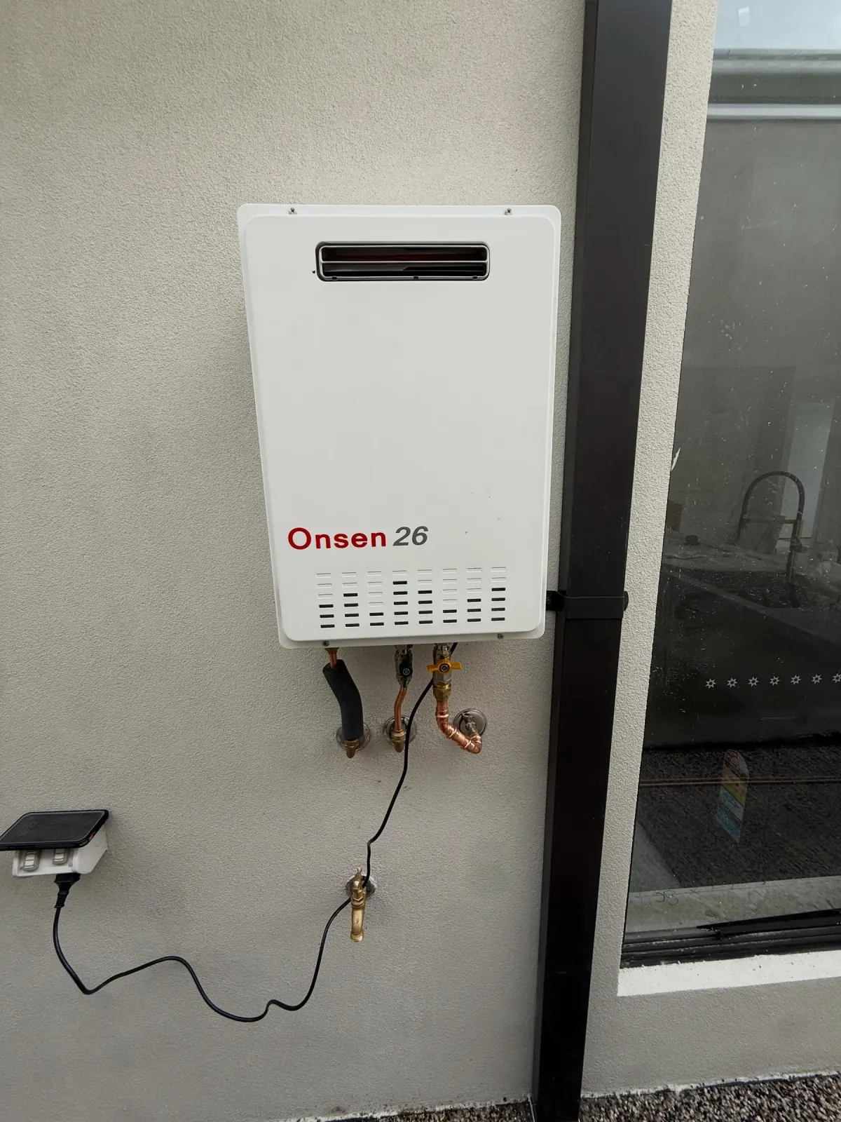 Wall-mounted instantaneous gas hot water unit with copper connections and isolation valve